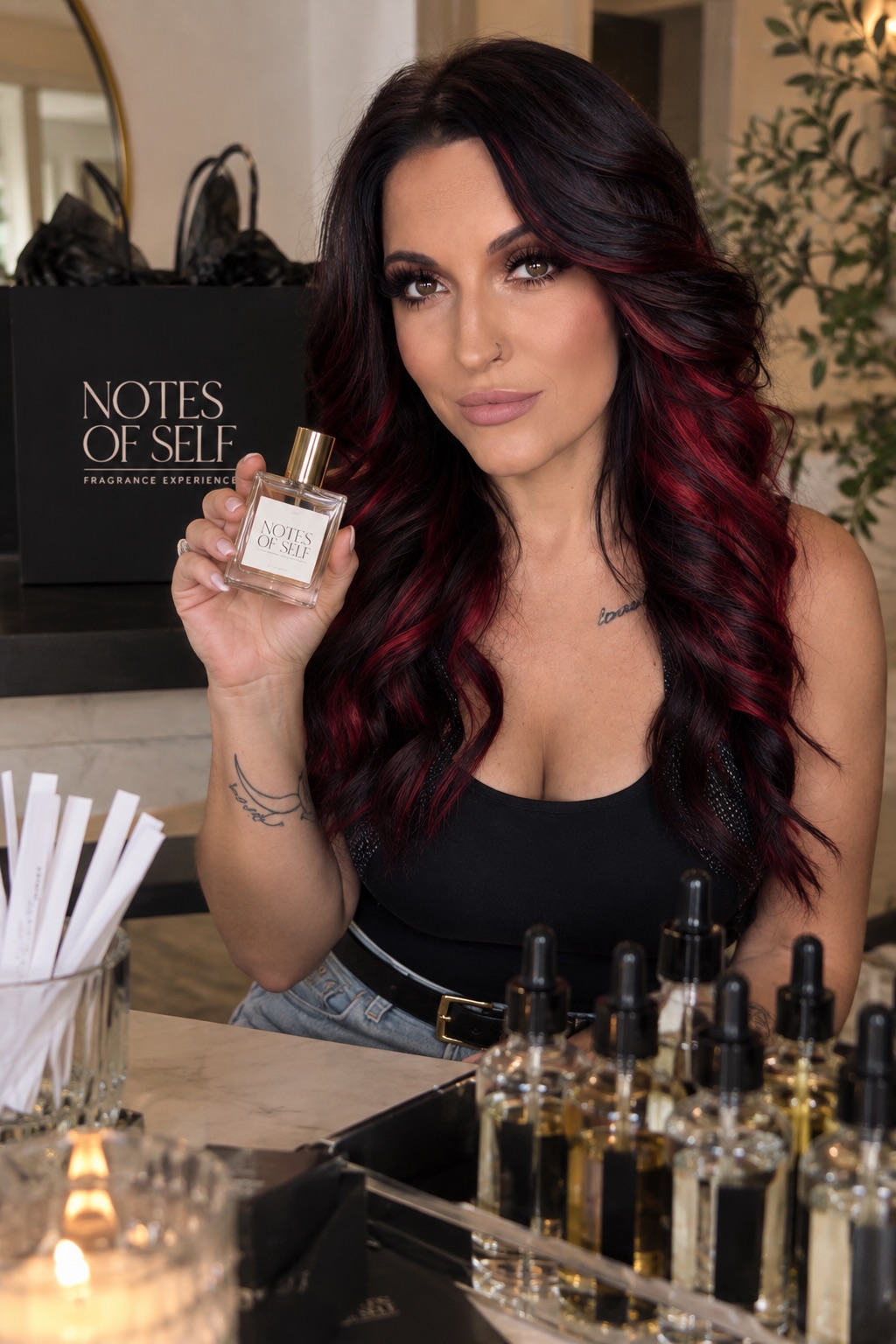 Katie, founder of Notes of Self, holding a custom fragrance at the fragrance bar
